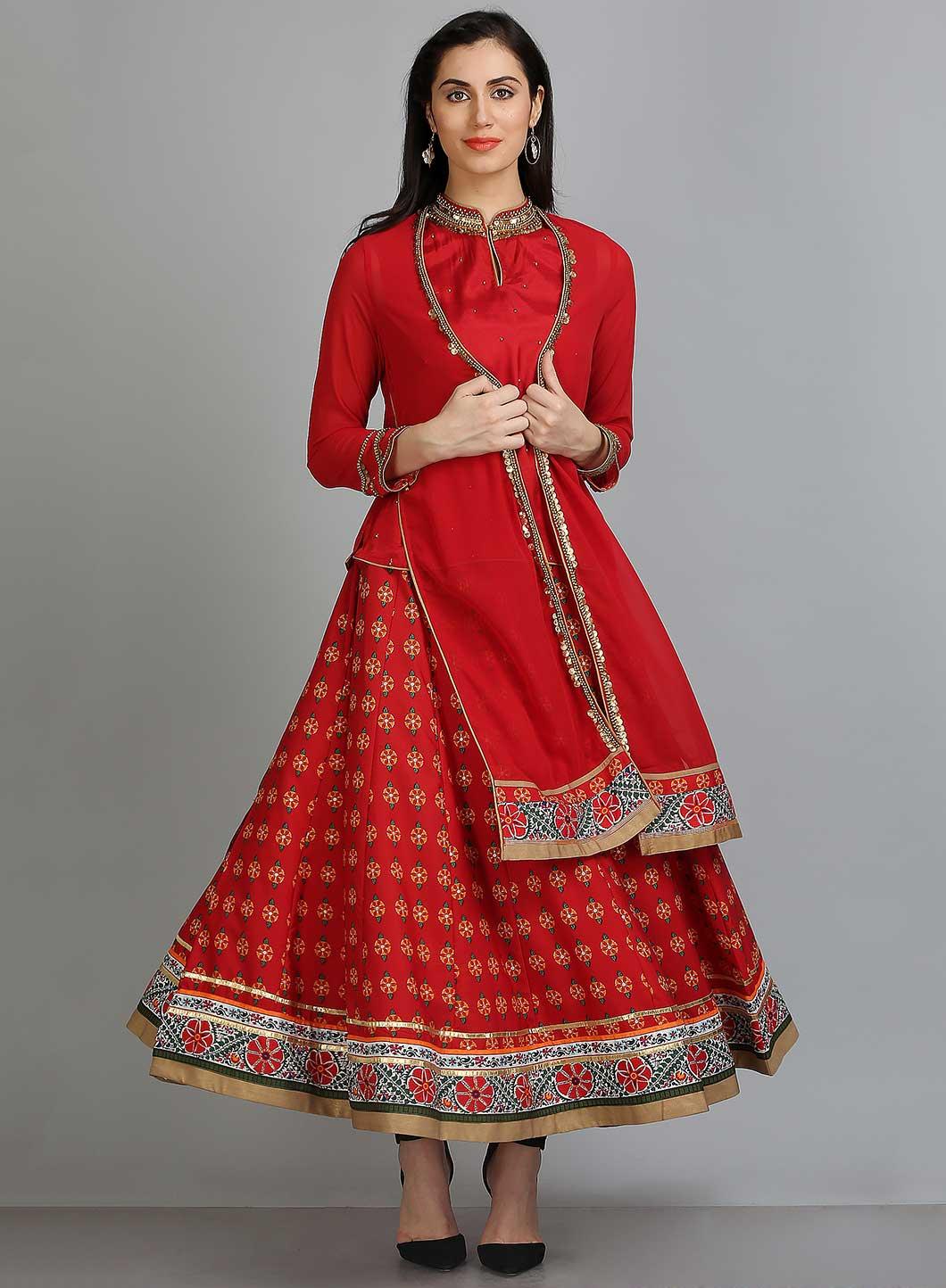 Woman in a red ethnic outfit with intricate designs and a flowing skirt